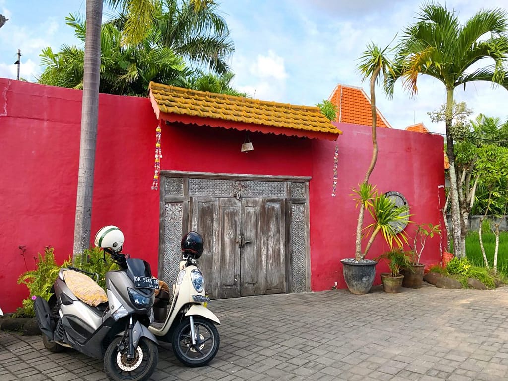 red walled building desa seni canguu bali yellow feather blog