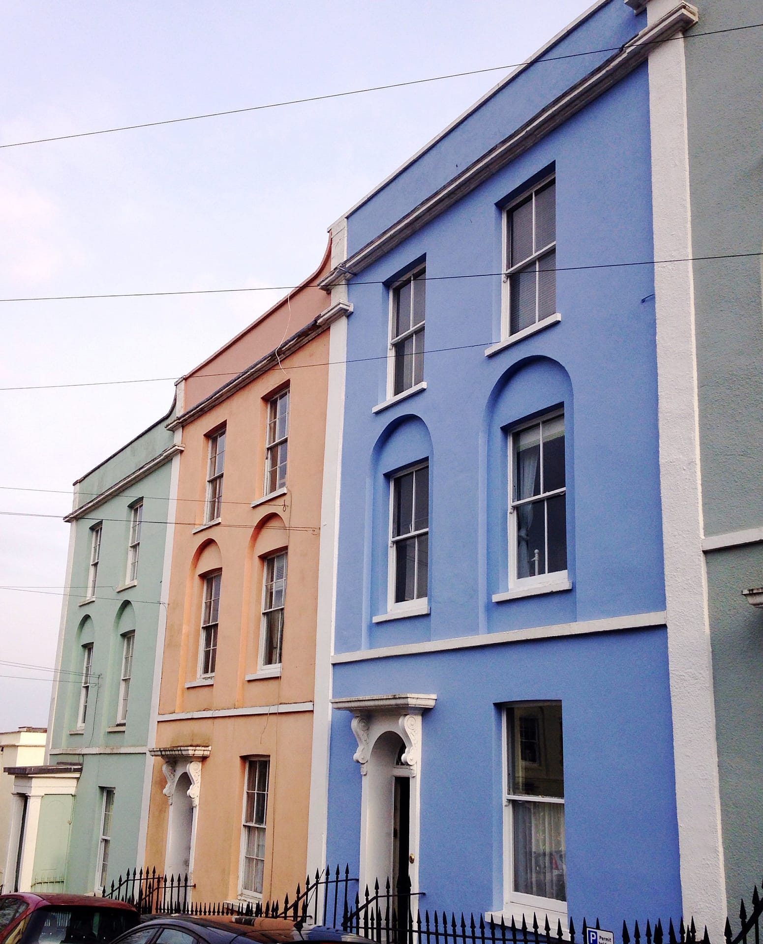 Mint green, coral and blue row of painted houses in Kingsdown Brisol